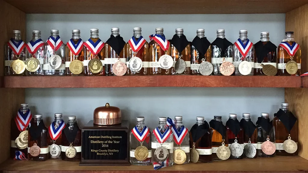 Medals placed around the necks of alcoholic drinks